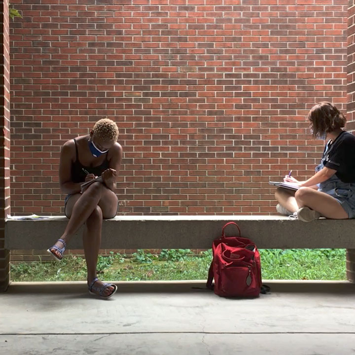 Two art students, Tamia and Calli, sit outside of the University of Tennessee at Chattanooga